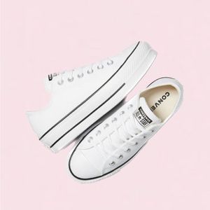 White women’s leather converse with black stripes size 9.5